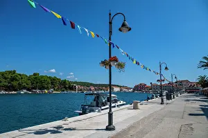 Lamps Prints: Colorful flags decorate the waterfront near boats in Stari Grad
