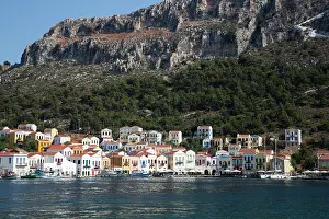 Dodecanese Prints: Colorful houses along the harbor in Megisti Bay with boats anchored in clear waters of Kastellorizo