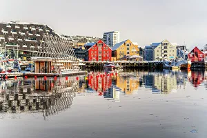 House Exterior Prints: Colorful houses by the harbor mirrored in the cold sea at dawn