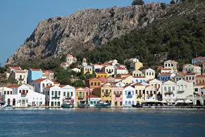 Navigation Prints: Colorful houses line the harbor as boats rest in Megisti Bay, Kastellorizo, Greece
