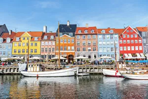 What's New: Colorful houses and moored boats in Nyhavn harbour, daytime, Copenhagen, Denmark, Scandinavia