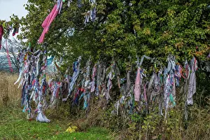 Ritual Prints: Colorful prayer flags hang from trees near St