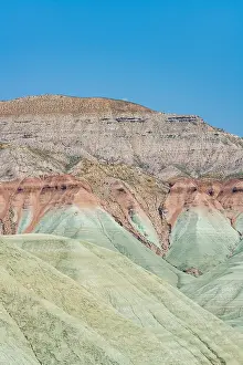 Wonders Prints: Colorful red mountains stand tall under a clear sky in Davutoglu