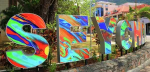 Bright Prints: Colorful sign celebrating Seychelles in Mahe with vibrant design and surrounding greenery