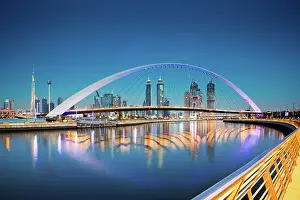 Marvels Prints: Colorful sunset over Dubai Downtown skyscrapers and newly built Tolerance Bridge seen from the Dubai water canal
