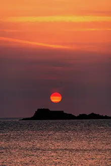 Retreat Prints: Colorful sunset behind Fort National seen from the shoreline in Saint-Malo