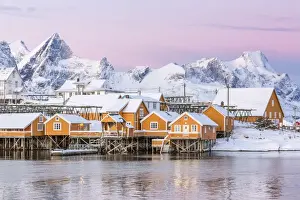 Sakrisoy Prints: The colors of dawn frame the fishermens houses surrounded by frozen sea, Sakrisoy