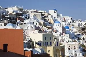 Coloured houses and church with blue dome in the evening light, Oia, Santorini, Cyclades, Aegean Sea, Greek Islands