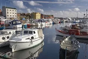 Images Dated 21st September 2008: Colourful boats and picturesque gabled buildings along the quayside in Vestaravag harbour