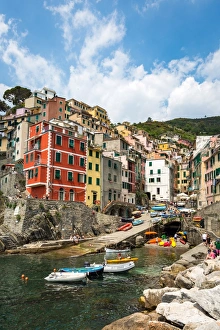 The colourful buildings and boats in Riomaggiore harbour, Cinque Terre, UNESCO World Heritage Site
