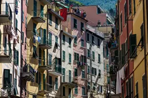 Cinque Terre Prints: The colourful buildings of Riomaggiores main street in the early morning sunlight