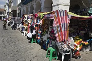Cuenca Prints: Colourful clothing and textiles for tourists in the market on Plaza San Francisco
