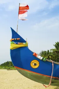 Kerala Prints: Colourful fishing boat with Indian flag and golden eye motifs on Marari Beach