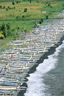 Colourful prahu (fishing boats) lining the beach