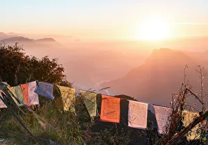 Prayer Flag Prints: A colourful sunrise over the mountains of the Anapurna range