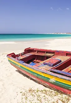 Typically African Prints: Colourful traditional local fishing boat on the beach at Santa Maria, Praia da Santa Maria