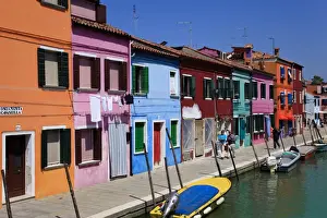 Colourfully painted houses situated on canal banks on the island of Burano