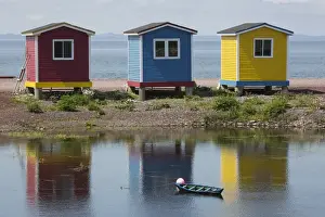 Canadian Culture Prints: Colourfully painted huts by the shore of the Atlantic Ocean at Hearts Delight-Islington