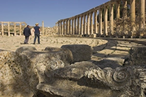 Forum Prints: Column capital in foreground and visitors walking in Forum