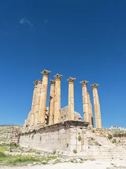 Jerash Prints: Columns frame a building in the ancient city of Jerash