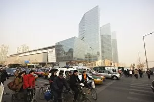 Commuters on bicycles and car drivers in the Central Business District business district, Guomao area