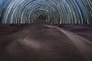 Starry Sky Prints: Concentric circumpolar star trail above sand dunes in the Rub al Khali desert, Oman