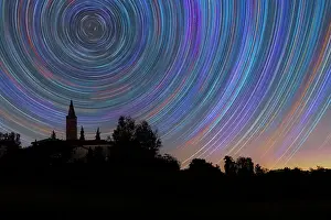 Star Prints: Concentric star trail over a bell tower in the Italian countryside