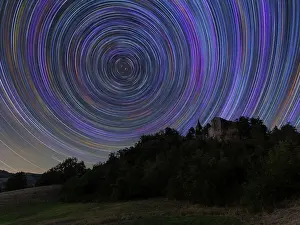 Star Prints: Concentric star trail over a medieval castle in the Italian countryside