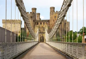 United Prints: Conwy Suspension Bridge crosses River Conwy with Conwy Castle seen in the background in Wales