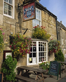 Hanging Basket Prints: The Cotswold Arms Hotel in the town of Burford in the Cotswolds, Oxfordshire