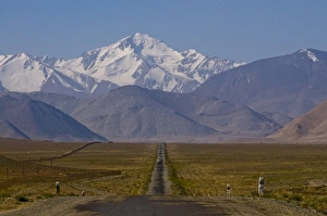Images Dated 26th August 2009: Country road leading to snow covered mountains, Karakul, Tajikistan, Central Asia