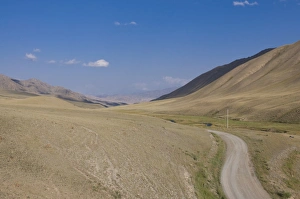 Dirt Road Prints: Country road leading into wilderness, near Song Kol, Kyrgyzstan, Central Asia