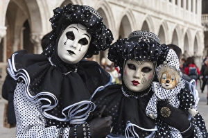 Identity Prints: Couple in black and white with clown puppet, Venice Carnival, Venice, Veneto, Italy