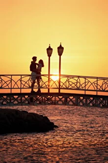 Love Collection: Couple on bridge at sunset, Aruba, West Indies, Dutch Caribbean, Central America