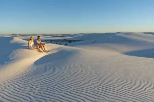Rippled Gallery: A couple enjoys White Sands National Park at sunset, New Mexico, United States of America