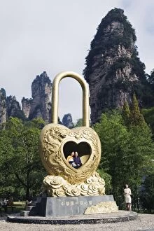 Images Dated 3rd November 2008: A couple in a giant love heart lock, Zhangjiajie Forest Park, Wulingyuan Scenic Area