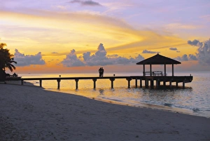Images Dated 30th June 2008: Couple on jetty looking at sunset, Maldives, Indian Ocean, Asia