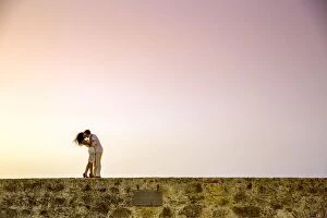 Couple posing on the old wall, Old Walled-in City, Cartagena, Colombia, South America