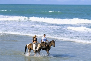 Rio Grande Do Norte Prints: Couple riding horses on the beach, Tibau do Sul, Natal, Rio Grande do Norte state