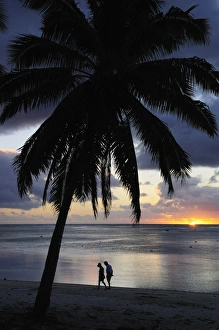 Couple walking on beach, Paradise Cove, Aitutaki, Cook Islands, South Pacific Ocean