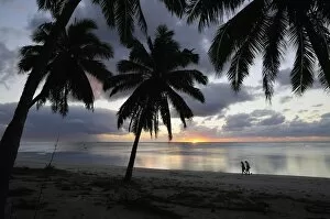 Couple walking on beach, Paradise Cove, Aitutaki, Cook Islands, South Pacific Ocean