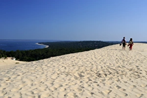 Couple walking on the Dunes du Pyla, Bay of Arcachon, Cote d'Argent Couple walking on the Dunes du Pyla, Bay of Arcachon, Cote d'Argent