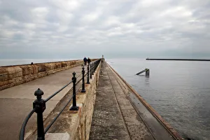 Jetty Gallery: Couple walking on the North Pier at Tynemouth, North Tyneside, Tyne and Wear, England