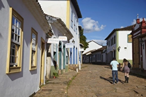 Stereotypically Brazilian Prints: Couple walking along street, Tiradentes, Minas Gerais, Brazil, South America