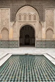 Patterned Prints: Courtyard and pool with traditional Moroccan ornate doorway in the Ben Youssef Medersa