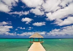 Covered Pier in the turquoise water of the Indian Ocean on the beach of Longoni