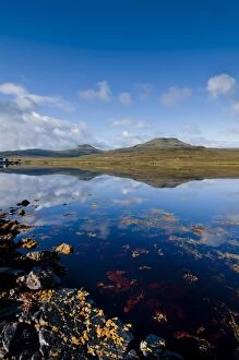 Images Dated 25th August 2010: Craggy seascape of Loch Dunvegan on the Isle of Skye, with Macleods Table in background
