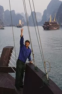 Crewman raises anchor on junk Ha Long Bay, Vietnam, Indochina, Southeast Asia, Asia