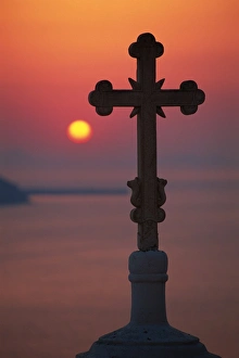 Fira Prints: Cross on church dome with setting sun behind