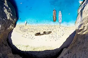 Shipwreck Prints: Crowd of tourists sunbathing on the idyllic Shipwreck Beach (Navagio Beach)